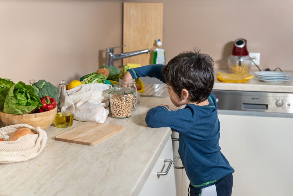 Little boy exploring kitchen.