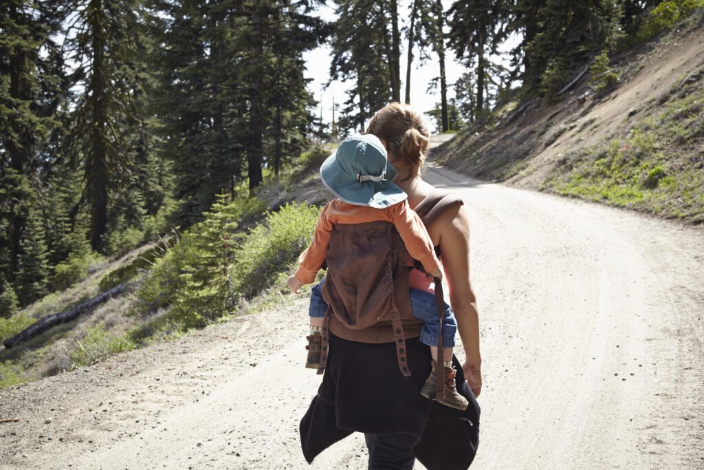 rear view of mother carrying toddler in baby carri 2022 03 07 23 57 45 utc